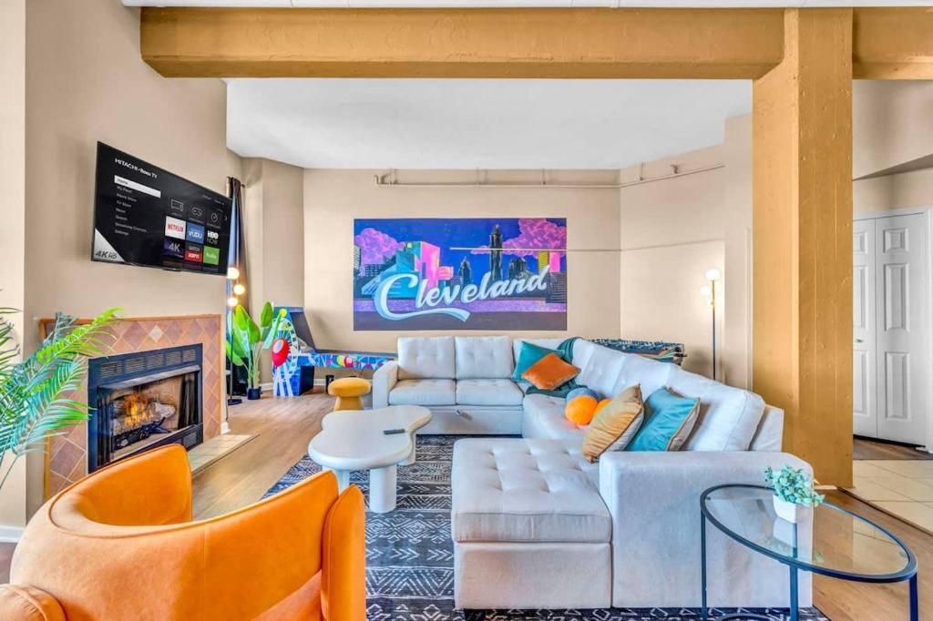 a living room with a couch and a fireplace at Fun 2Bed Apt Skeeball Foosball FREE Parking in Cleveland