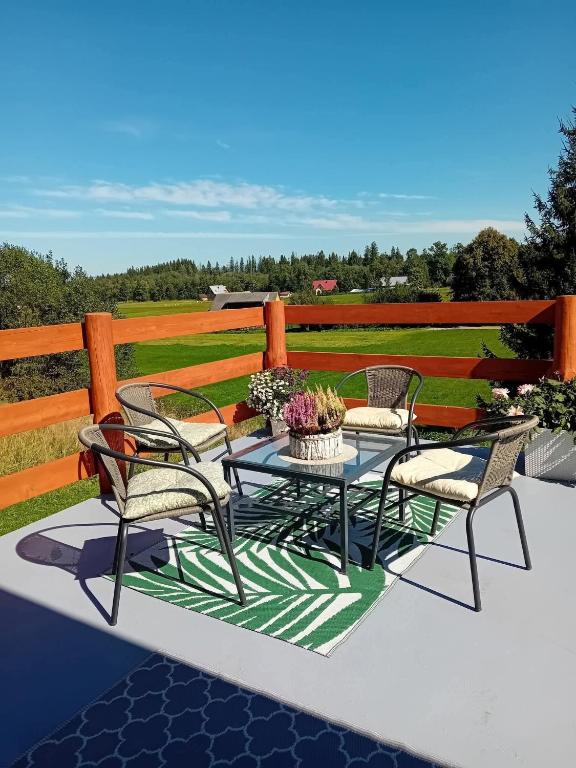 a group of chairs and a table on a patio at Apartament pod Lipa blisko Term Chochołowskich in Ratułów