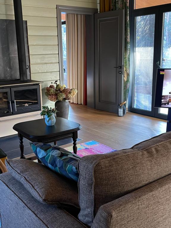 a living room with a couch and a table at Хлеча house in Stantsiya Korchi
