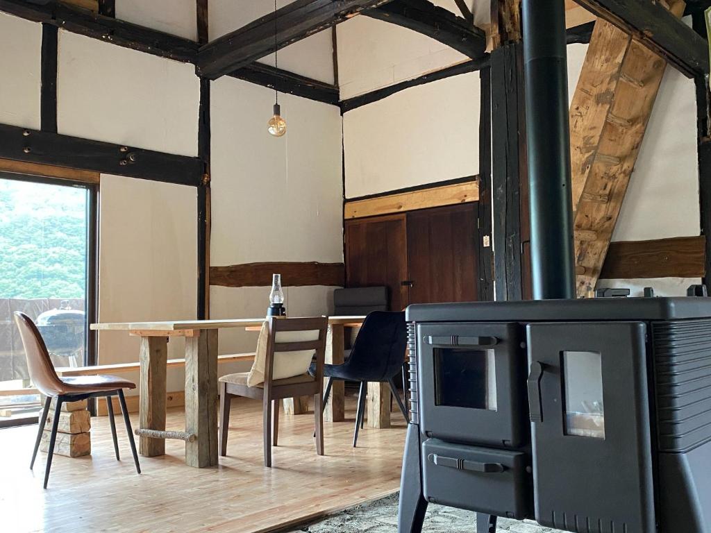 a living room with a table and a tv at La Cachette - Vacation STAY 34953v in Ina