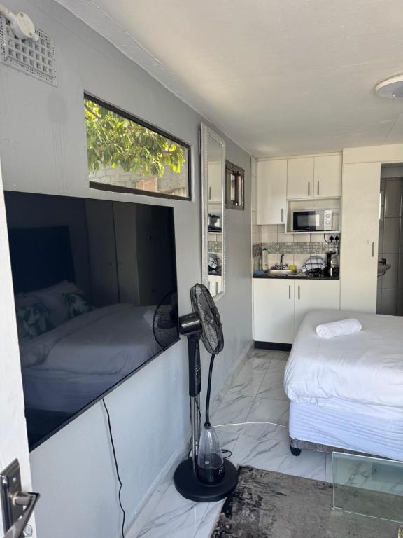 a room with two beds and a lamp in it at Legacy lodge in Goodwood