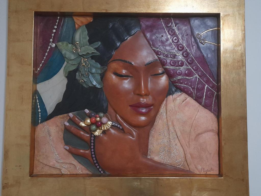 a painting of a woman holding a bunch of fruit at Atelier de lujo lucena in Lucena