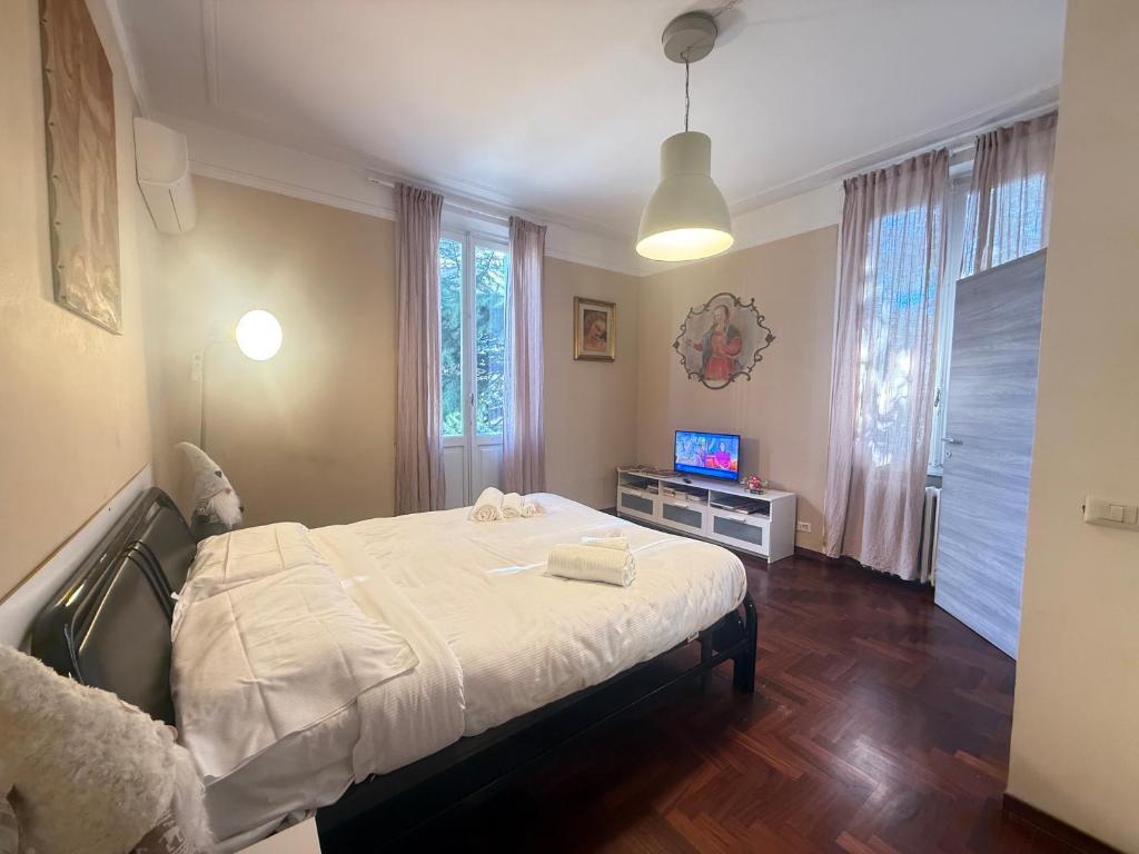 a bedroom with a bed and a tv in it at Garden suite / del ducato in Parma