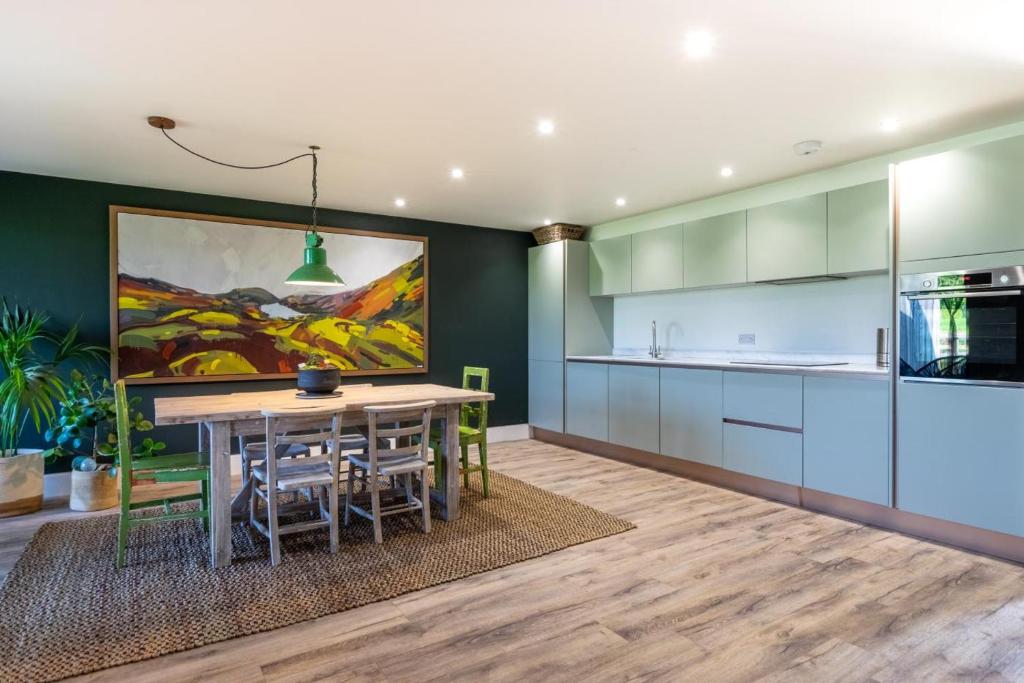 a kitchen with a table and a painting on the wall at 3 Bed in Henham oc-3nvf in Wangford