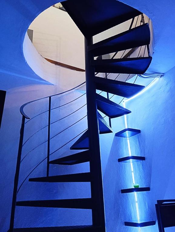 a staircase in a room with a blue ceiling at Loft Bovisa in Milan