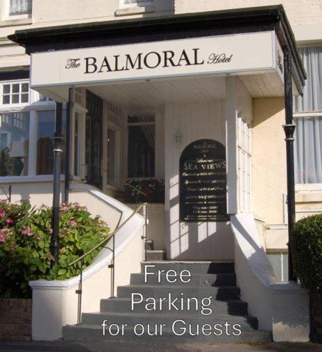 a building with a sign that reads free parking for our guests at Hotel Balmoral in Bournemouth
