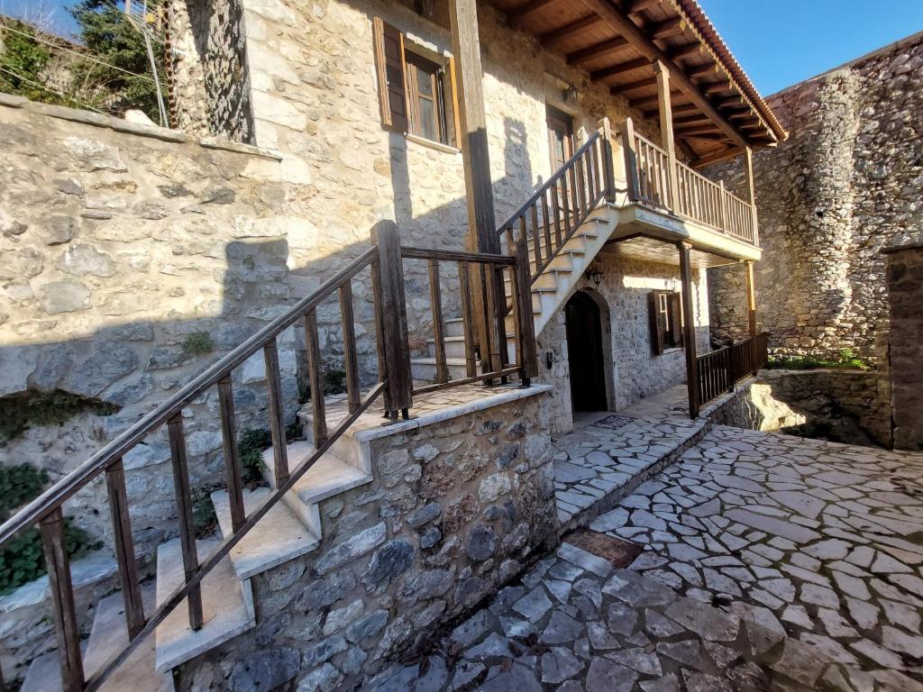 a stone building with a staircase and a stair case at Andromahi Stone House in Stemnitsa
