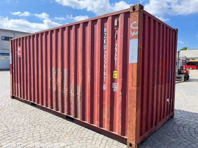 a red container sitting on the side of a parking lot at Abc in Primavera do Leste
