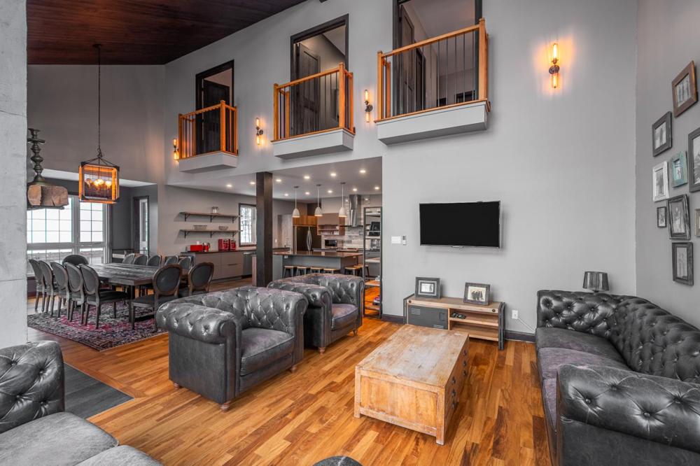 a living room with leather couches and a table at Blanc40 in Stoneham