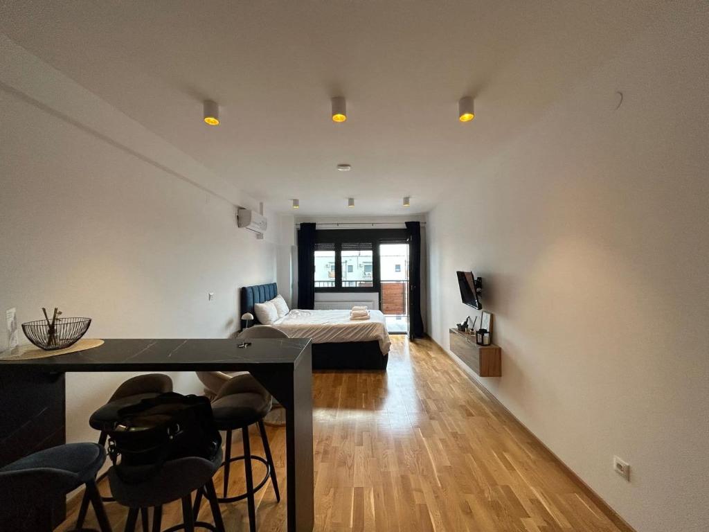 a living room with a bed and a table and chairs at Harmony Studio Suite in Jagodina