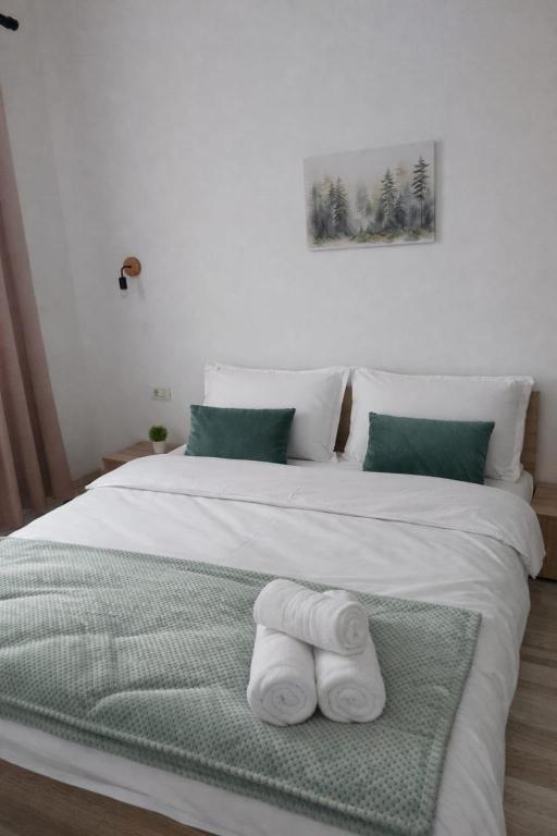 a white bed with two folded towels on it at Hera Exclusive Stay 2 in Timişoara