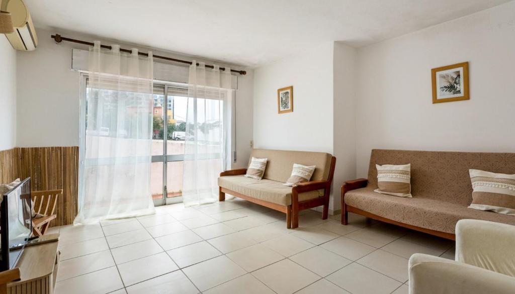 a living room with a couch and a chair at El Shaddai 3 in Atalaia