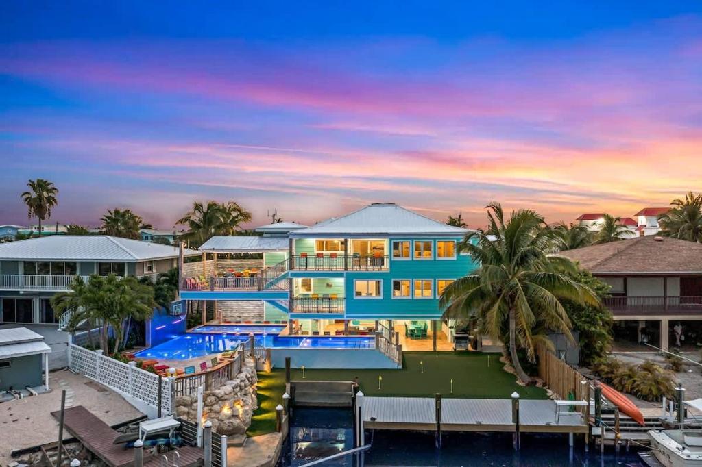 a large blue building with a swimming pool at Bumpa's Big House in Marathon