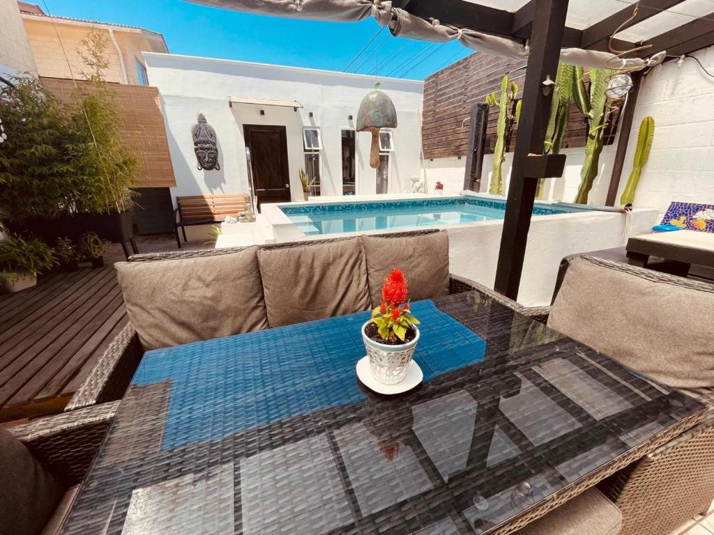 a table with a vase of flowers on top of a patio at Tayka Suite in La Serena