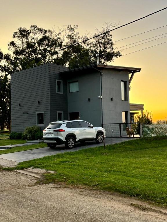 a white car parked in front of a house at Sol de campo in Santa Clara del Mar