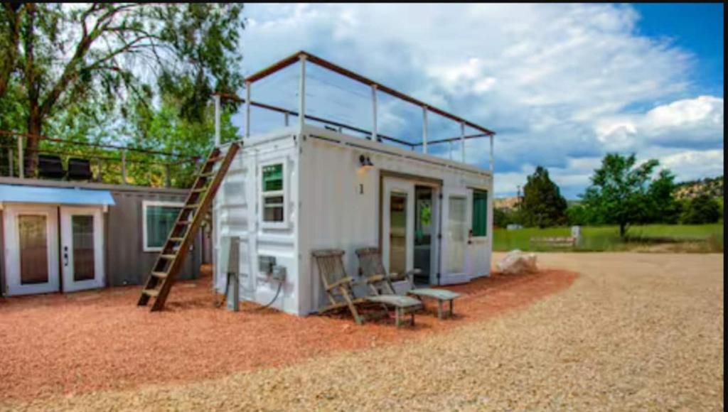 a tiny house with a ladder and a slide at NEW! Cozy Container Home at Cliffside #1 in Orderville