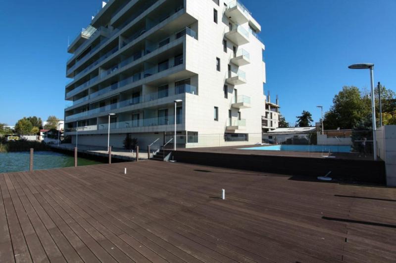 a large white building next to a large building at Tudor S Residence Mamaia in Văleni