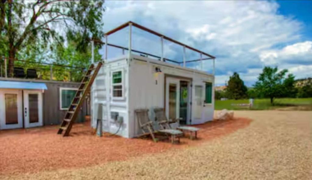 a small house with a ladder and a slide at NEW! Cozy Container Home at Cliffside #3 in Orderville