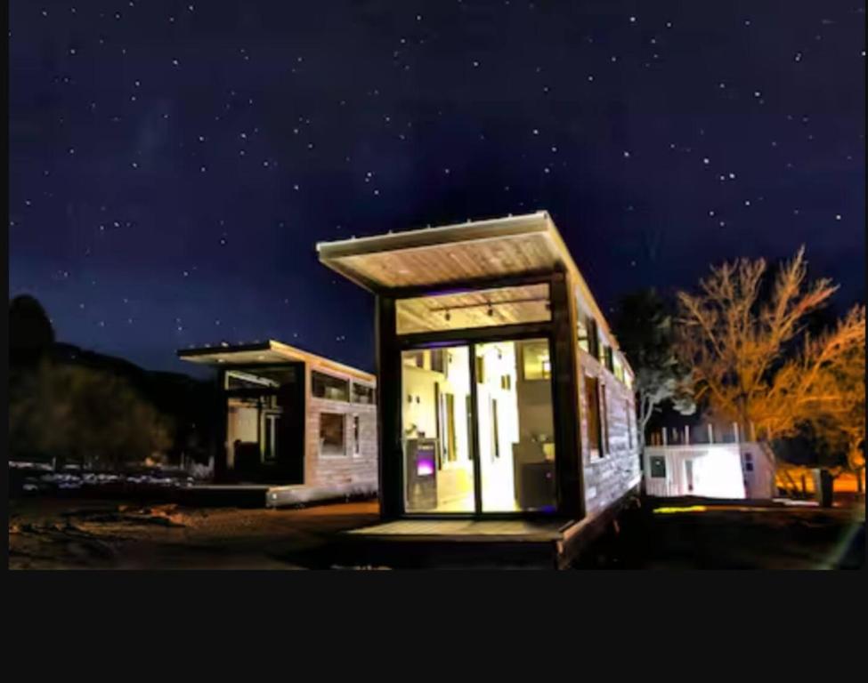 a gas station at night with the lights on at NEW! Modern Cabin Tiny Home at Cliffside #1 in Orderville