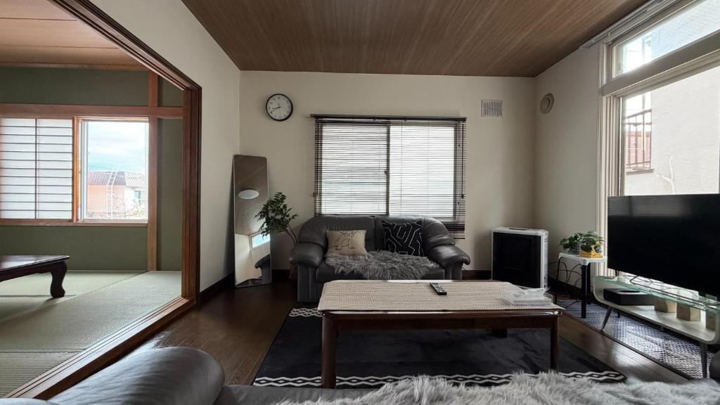 a living room with a couch and a table at SECONDHOUSE WINTER - Vacation STAY 24982v in Kita-hamachō