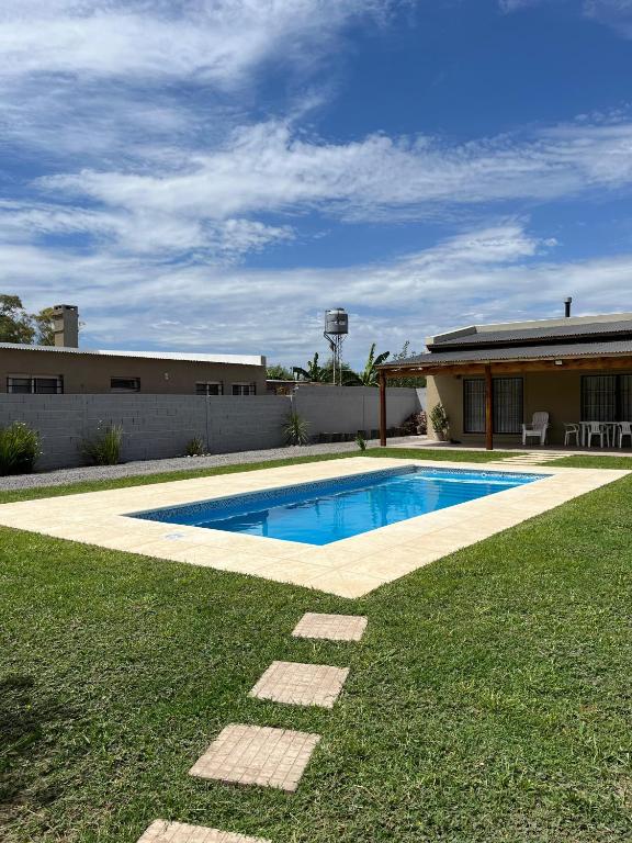 a swimming pool in the yard of a house at La Matera de Hugo in Lobos