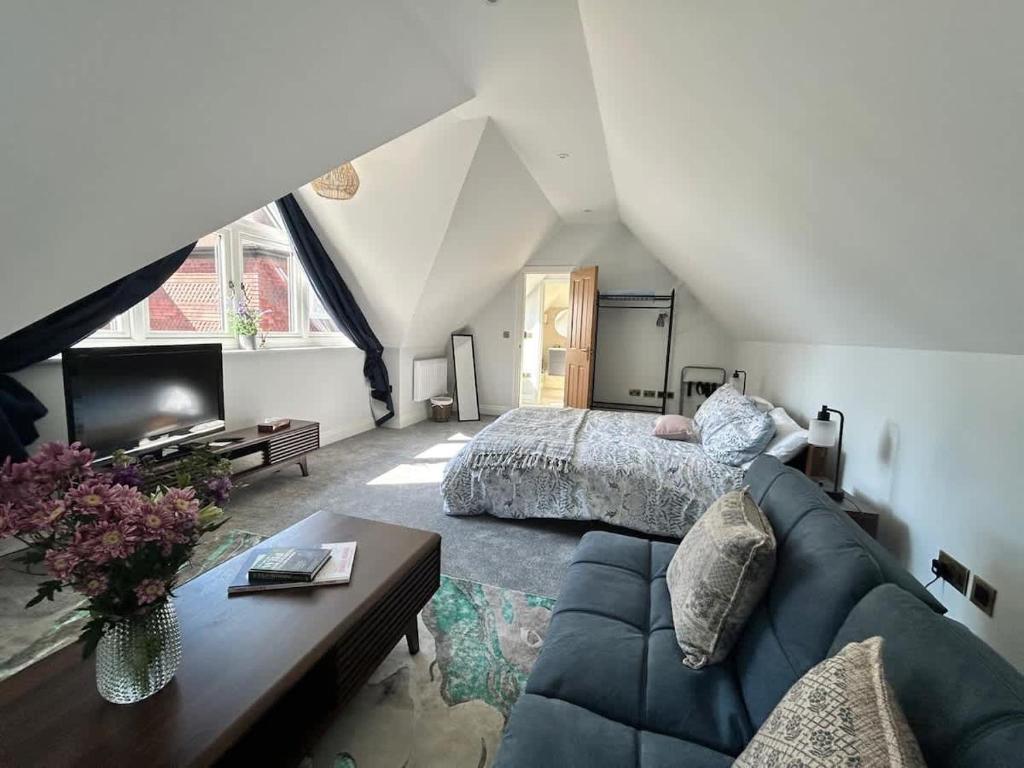 a large bedroom with a bed and a couch at Goring River Retreat with Gym and Wellness Area in Goring