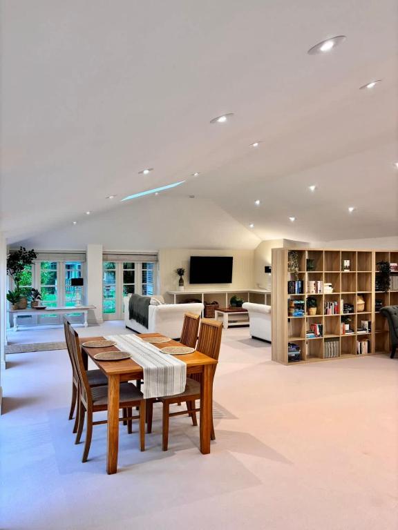 a living room with a table and chairs and a couch at The Baydon House Luxury Studio in Marlborough