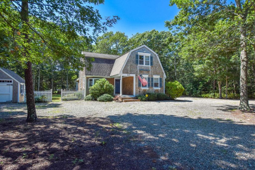 a house with a flag on the front of it at Large Great Location Dog Friendly in Dennis