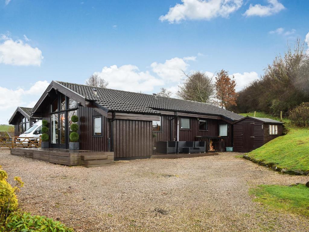 a house with a gravel driveway in front of it at Glendowlin Lodge Retreat in Tirril