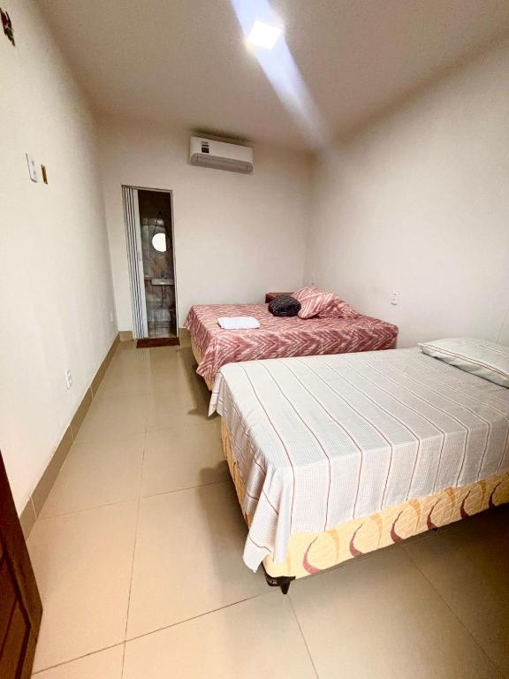 a room with two beds in a room with at Pousada Sol Nascente in Morros
