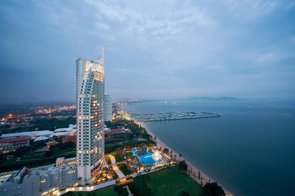 an aerial view of a tall building next to the water at Mövenpick Siam Hotel Na Jomtien Pattaya in Na Jomtien