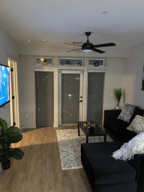 a living room with a couch and a ceiling fan at Deep Ellum Lux in Dallas