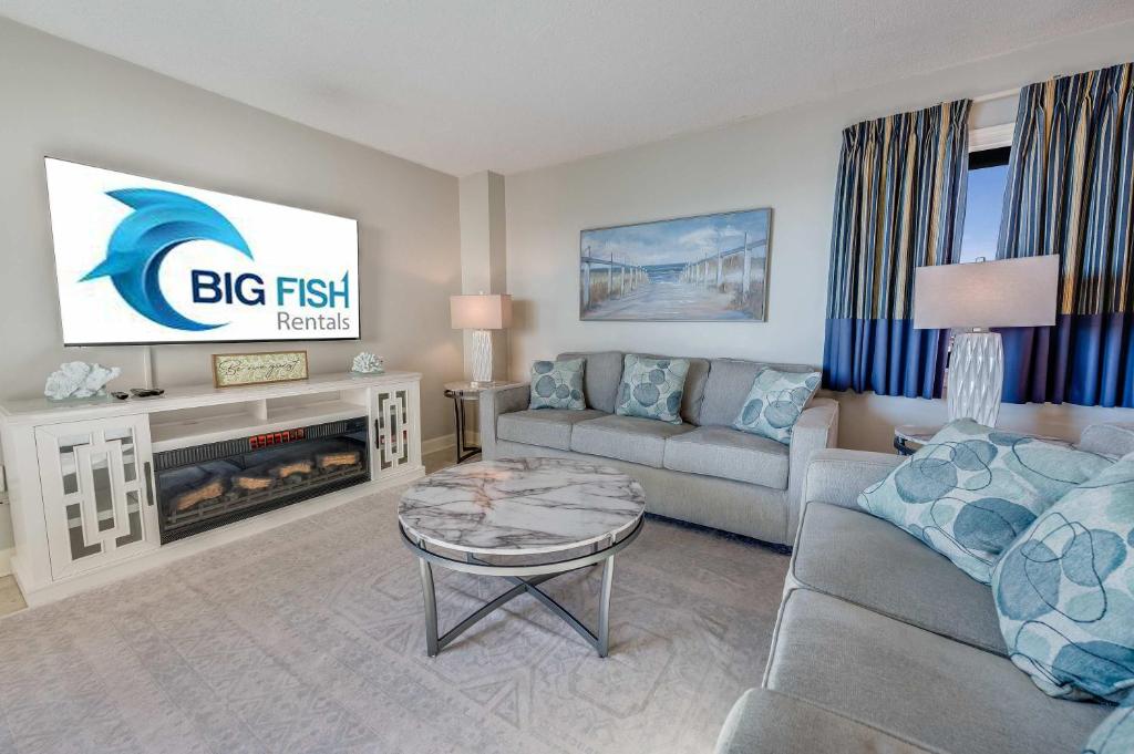 a large living room with a couch and a fireplace at Sea Pointe 2BR Condo Oceanview, Views, Large Condo in Myrtle Beach