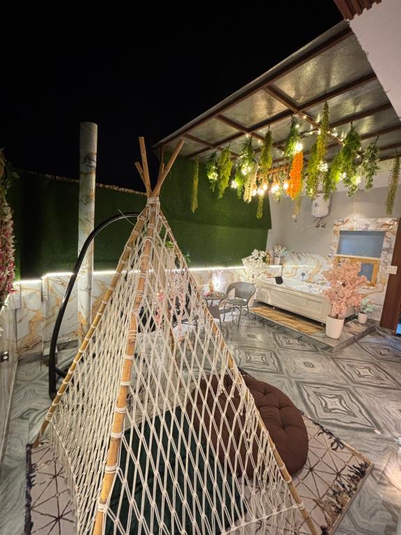 a hammock in the middle of a room at The terrace affair studio with jacuzzi in Gurgaon