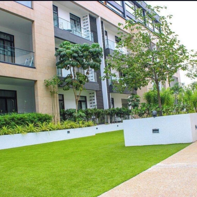 a large building with a lawn in front of it at Embassy Onebedroom by Unique Abodes in Accra