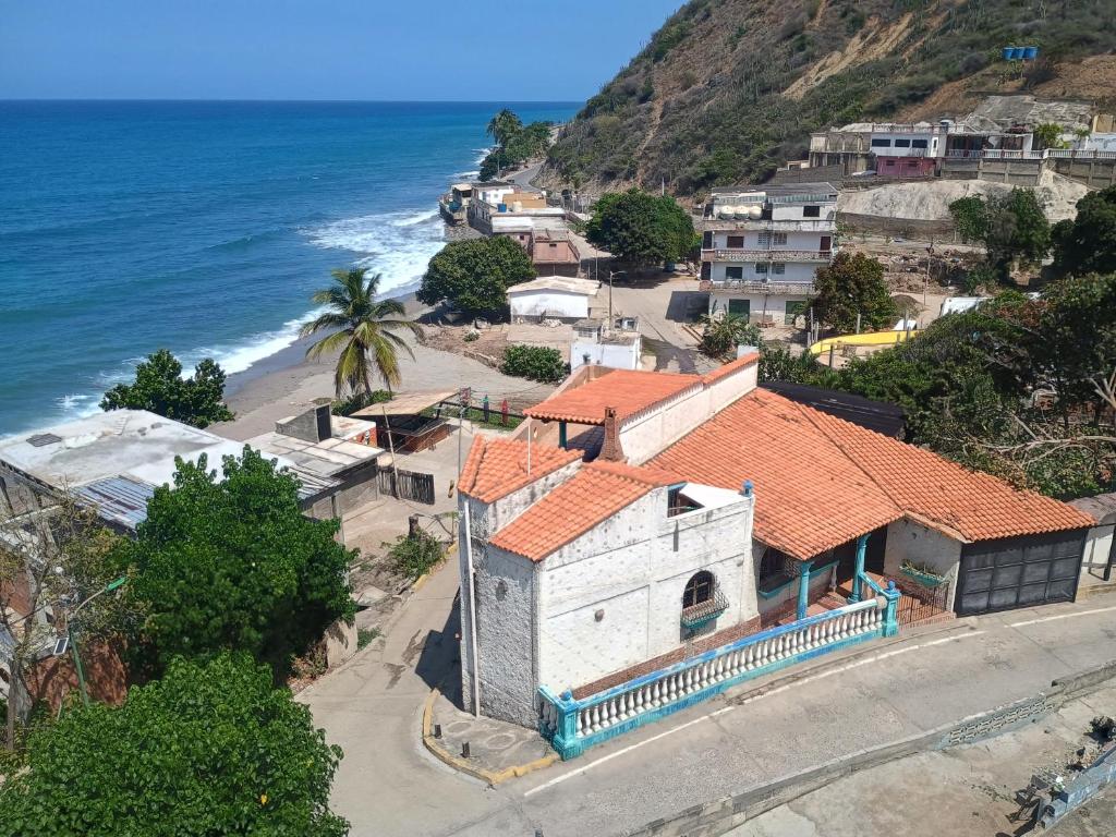 an aerial view of a house next to the ocean at Casa Cerdeña in Puerto Carayaca