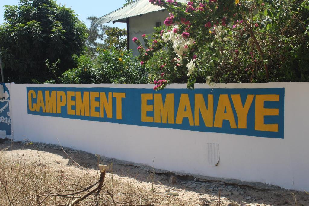 a sign on a wall that reads equipmentamine at Campement Emanaye in Oussouye