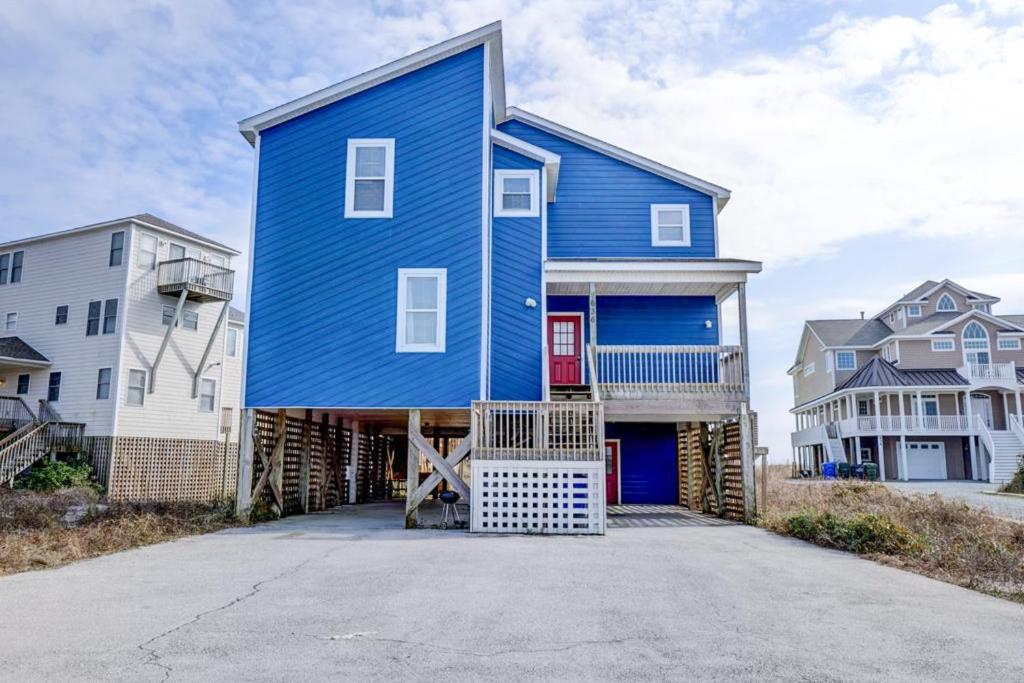 a house with a blue house at NTBHC636 Whale Den in North Topsail Beach