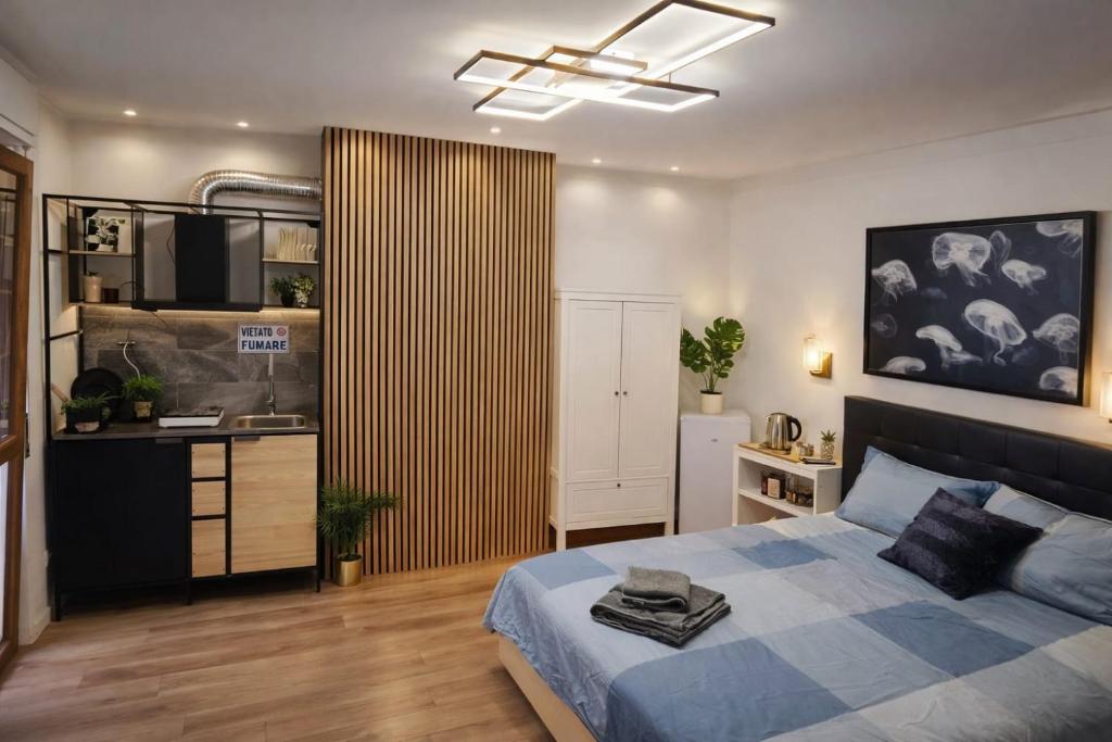 a bedroom with a bed and a kitchen in it at Moonlight Etna B&B Catania in Catania