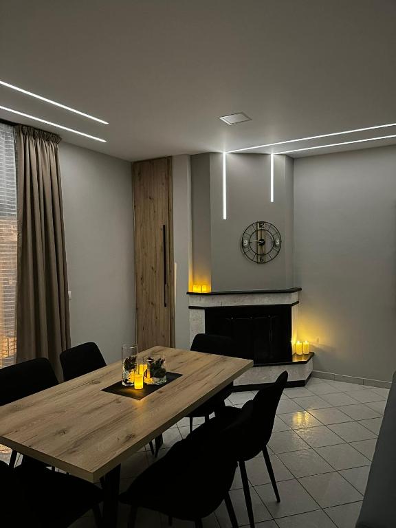 a dining room with a table and a fireplace at Με θέα το Κάστρο Apartment in Nafpaktos