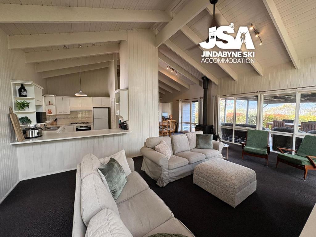 a living room with two couches and a kitchen at Kalkite Cottage in Kalkite