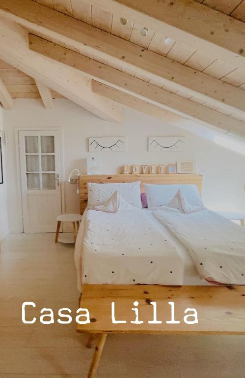 a bedroom with a large white bed in a room at Casa Lilla in Gravedona