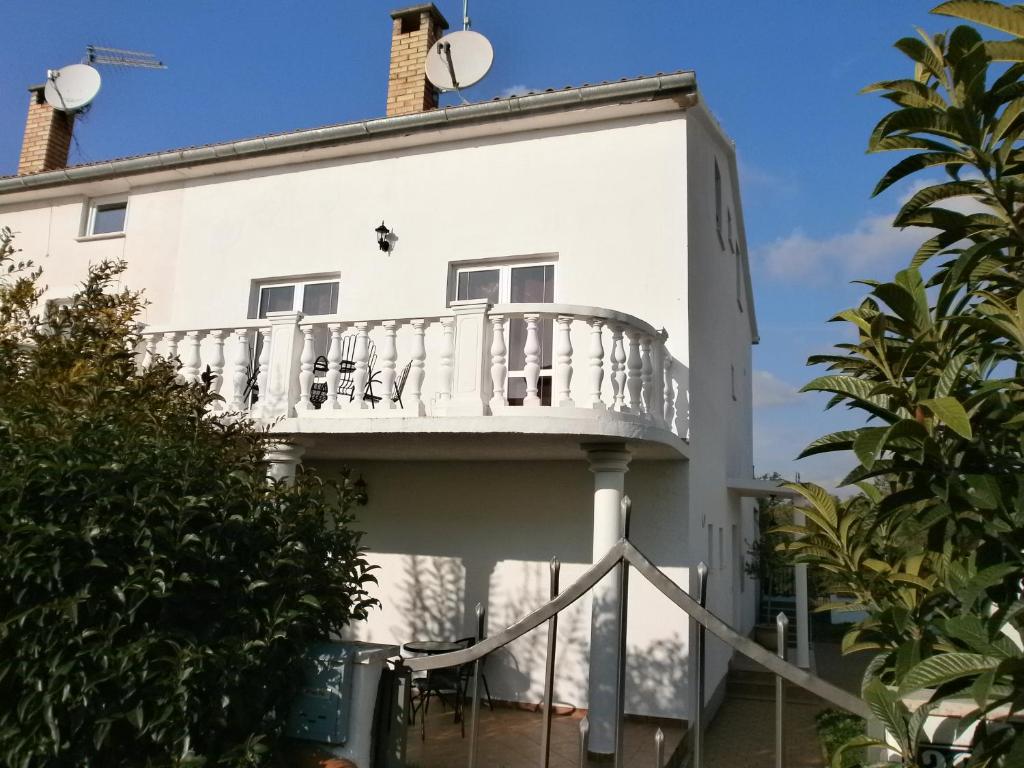 a house with a balcony on the side of it at Apartments Oliva in Poreč