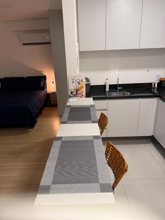 a kitchen with a long table in a room at SeuLoft 110SouMais in Niterói
