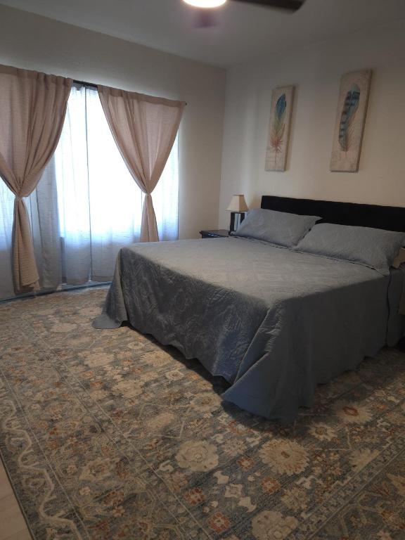 a bedroom with a large bed and a window at Twin Nest Duplex in Irving
