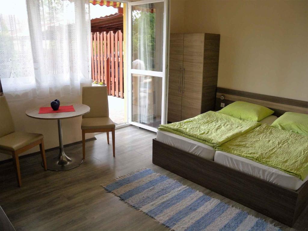 a bedroom with a bed and a table and a window at Studios near Beach in Balatonfoeldvar 18525 in Balatonföldvár