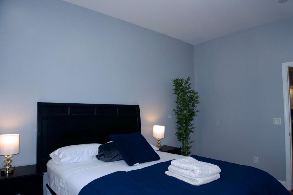 a bedroom with a large bed with towels on it at New York Private room 30 in West New York