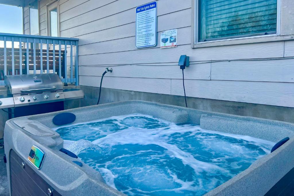 a jacuzzi tub with blue water in front of a building at San Antonio Home w/ Hot Tub: Near Golf & Shopping in San Antonio
