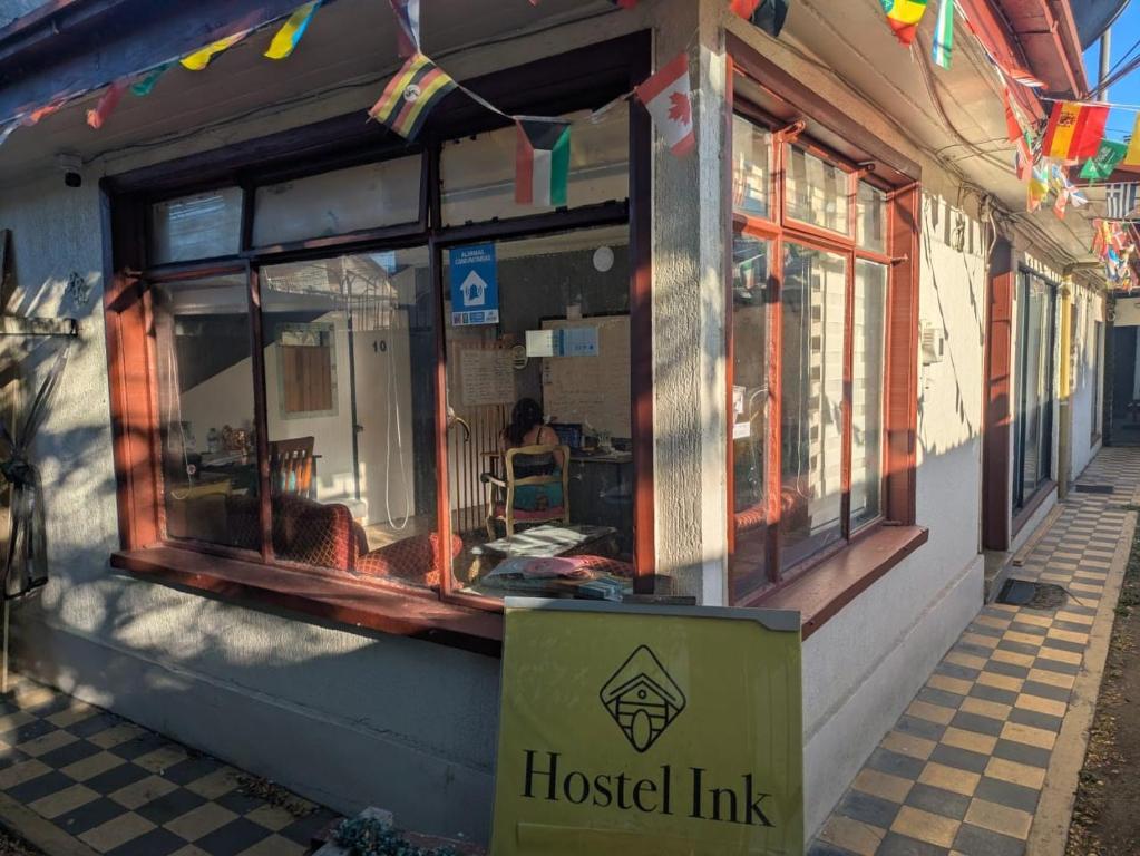 a hospital link store front with a sign in front at Hostel INK - Duerme Como En Casa in Concepción