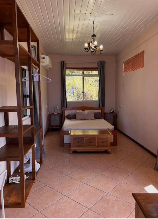 a bedroom with a bed and a ladder and a window at Vue d'Ô in Taputapuapea